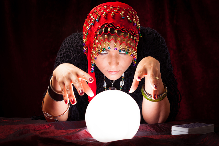 Portrait Of Mysterious Fortune Teller Gesturing At Crystal Ball